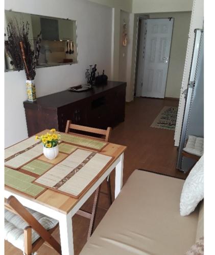 a table and chairs in a living room with a kitchen at Cozy apartment in the hart of the city in Varna City