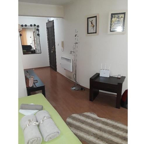 a room with a bed and a table and a desk at Cozy apartment in the hart of the city in Varna City