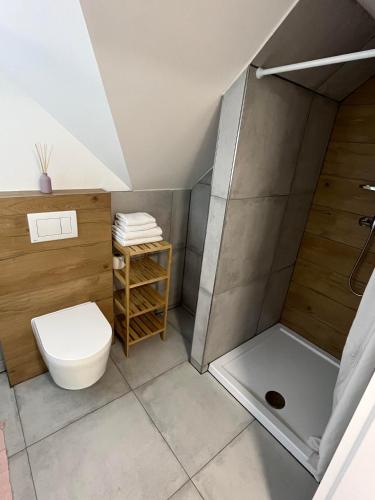 a bathroom with a toilet and a shower at Ubytovanie MARINEL in Bojnice
