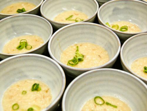 a group of white bowls filled with soup at Matsuyama Tokyu REI Hotel in Matsuyama