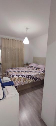 a bedroom with a bed and a couch in it at CasaBarreiro in Barreiro
