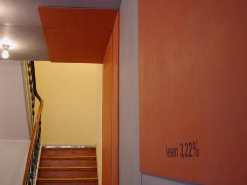 a hallway with a staircase and a stairwayexit sign on the wall at Wedina Budget in Hamburg