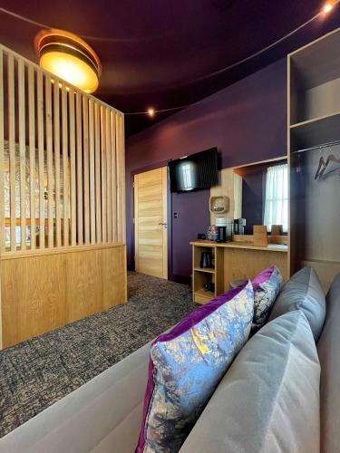 a living room with a couch and a kitchen at Lough Rooms at The Artisan in Strangford