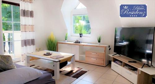 a living room with a tv and a table at Saphir Suite in Westerdeichstrich