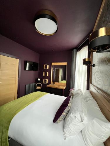 a bedroom with a large bed and a mirror at Lough Rooms at The Artisan in Strangford
