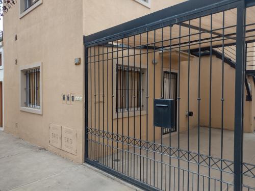 an open door of a building with bars at La Candida in Tunuyán