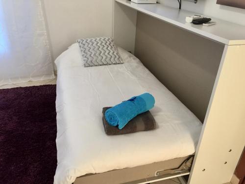 a bunk bed with a blue towel on it at Appartement Auber in Nice