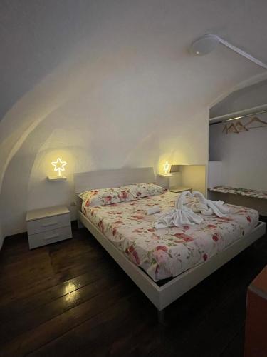 a bedroom with a bed with a white comforter at Guarracino P. Capodimonte Suite in Naples