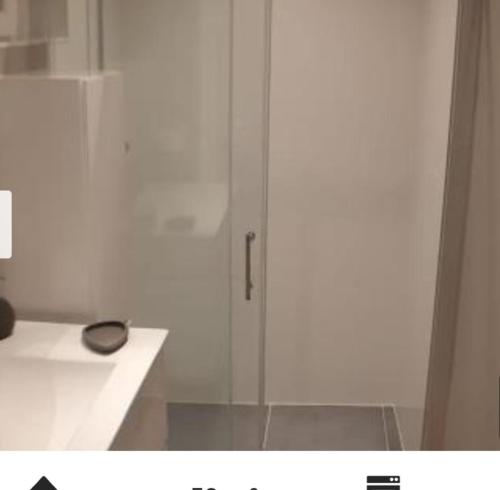 a white cabinet with a glass door in a bathroom at Terrasses de Malmedy Lodge 417 in Malmedy