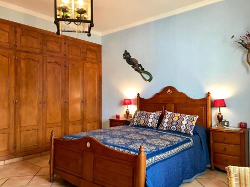 a bedroom with a wooden bed and wooden cabinets at Elegant Villa in Cartagena with Private Pool in Cartagena