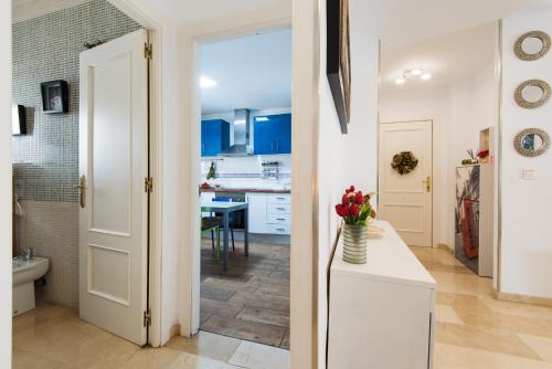 a kitchen with blue cabinets and a white door at NEW ROYAL TORREQUEBRADA 2 Pets friendly & ideal for family groups in Benalmádena