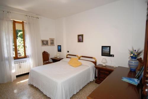 a bedroom with a bed and a table and a window at Apartment Vincenzina in Monterosso al Mare