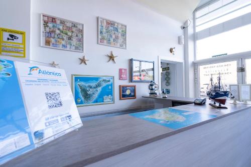 a room with a table with a sign on it at Hostel Neon Tenerife in Guaza
