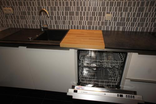 a kitchen with a dishwasher and a sink at J and R Brussels City Apartment in Brussels