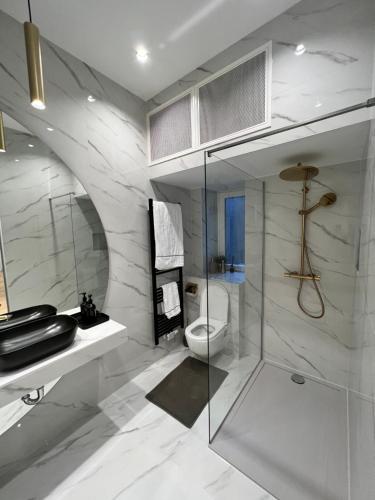 a bathroom with a toilet and a glass shower at SDesign Luxury Zagreb apartment in Zagreb