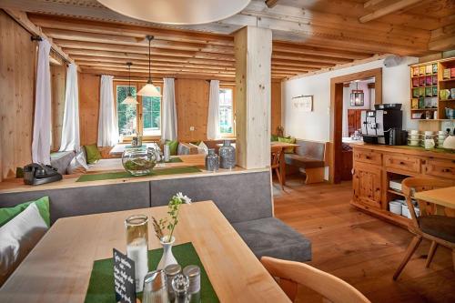 a living room with a table and a kitchen at Bio-Pension Bliem in Altenmarkt im Pongau