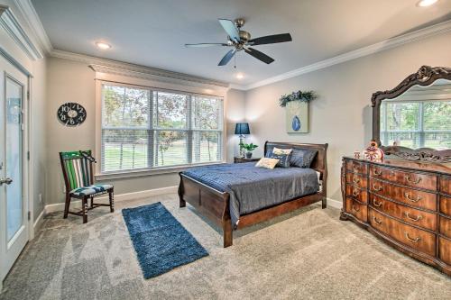 a bedroom with a bed and a dresser and a window at Golf Course View Hot Springs Village Home! in Hot Springs Village