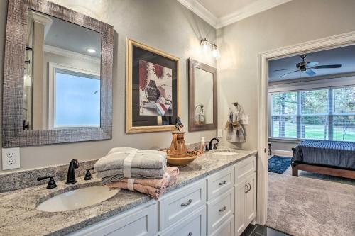 a bathroom with a sink and a mirror at Golf Course View Hot Springs Village Home! in Hot Springs Village