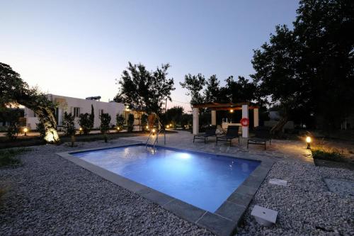 a swimming pool with a fountain in a yard at Elia suites in Ialysos