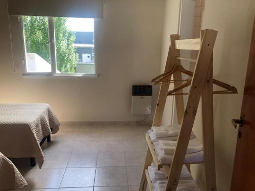 a room with a ladder and a bed and a window at CALAFATE CENTER APARTS in El Calafate