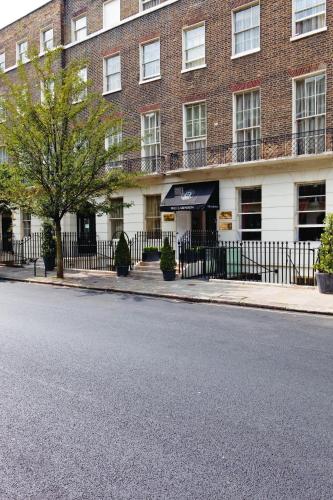 an empty street in front of a brick building at Grange Clarendon Hotel in London