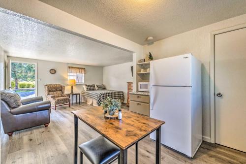 a living room with a refrigerator and a table at Ruidoso Downs Fritz Cabin with Covered Patio! in Ruidoso Downs