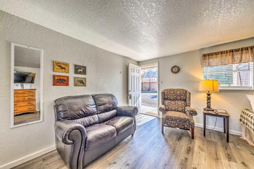 a living room with a leather couch and a chair at Ruidoso Downs Fritz Cabin with Covered Patio! in Ruidoso Downs