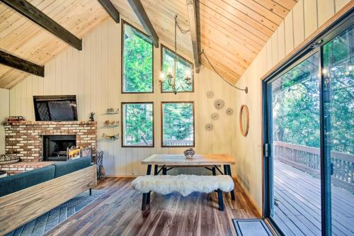 a living room with a table and a fireplace at Twin Peaks Cabin Less Than 4 Mi to Lake Arrowhead! in Twin Peaks