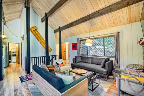 a living room with a couch and a table at Twin Peaks Cabin Less Than 4 Mi to Lake Arrowhead! in Twin Peaks
