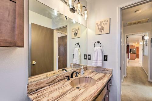 uma casa de banho com um lavatório e um espelho grande em Retro House with Deck and Arroyo Grande View em Arroyo Grande