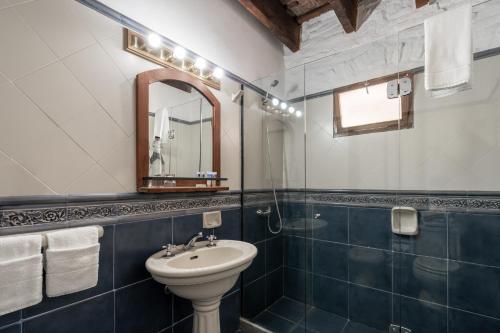 a bathroom with a sink and a mirror at Posada Manuel Lobo in Colonia del Sacramento