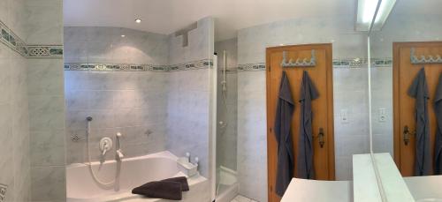 a bathroom with a tub and a shower and a sink at Haus Lawerz in Nauders
