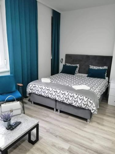 a bedroom with a bed and a chair and a table at Slatka Tajna in Banja Luka