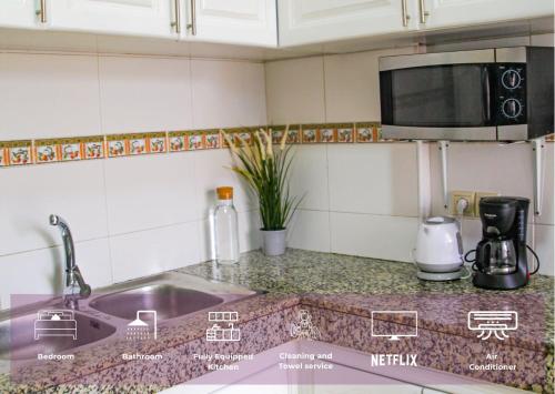 a kitchen counter with a sink and a microwave at YourPlace Rabat Agdal 1 - Cozy Residence in Rabat