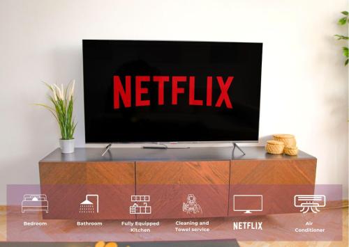 a television on top of a wooden entertainment center at YourPlace Rabat Agdal 1 - Cozy Residence in Rabat