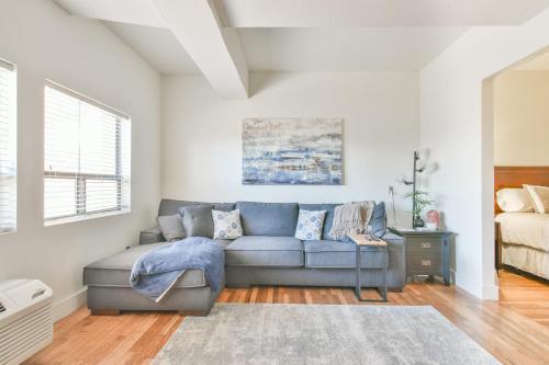 a living room with a couch and a bed at The Executive Loft - Walk to Sanford Stadium in Athens