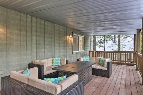 a porch with a table and chairs on a deck at Cold Springs Mountain Cabin Hot Tub and Generator in Cold Springs