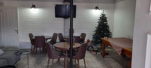 a living room with a christmas tree and a table and chairs at View Racha in Ambrolauri