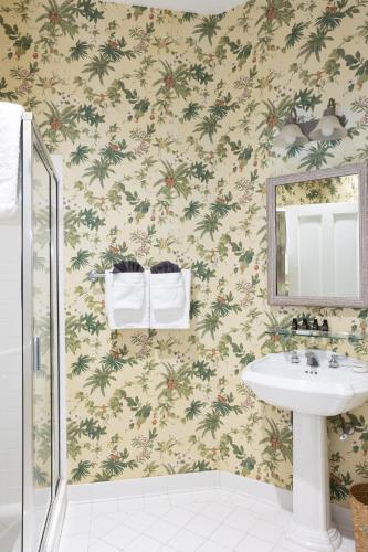 a bathroom with a sink and a mirror at The Cottages on Charleston Harbor in Charleston