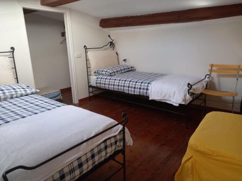 a room with two beds and a mirror at Vittoria 19 in Portovenere