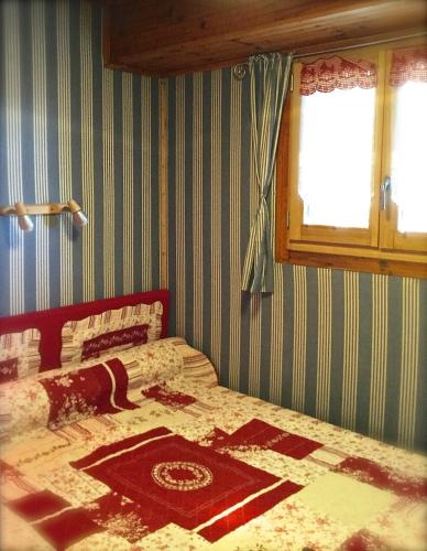 une chambre avec un lit avec une couette dessus dans l'établissement Appartement au pied des pistes, à Saint-Lary-Soulan
