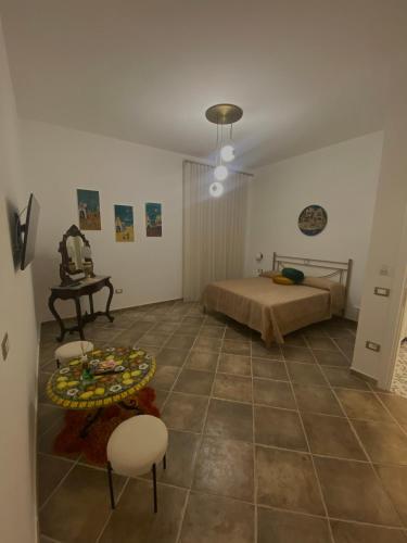 a bedroom with a bed and a table and chairs at Palazzo Della Guardia in Vietri sul Mare