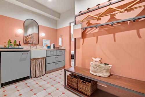 a kitchen with pink walls and a sink and a counter at Hotel Trouvail Miami Beach in Miami Beach