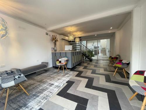 a living room with a couch and chairs on the floor at WINDAY HOTEL - Cerca 5a Avenida in Playa del Carmen