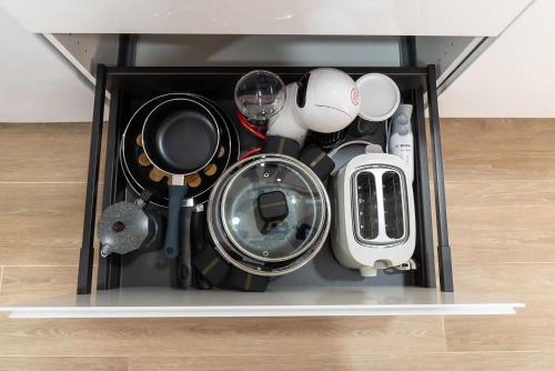 a drawer filled with dishes and other kitchen utensils at Vivienda Turística Playa El Portil in El Portil