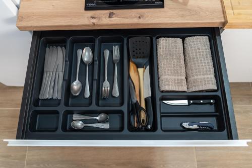 a black tray with utensils in a drawer at Vivienda Turística Playa El Portil in El Portil