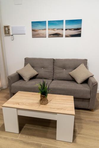 a living room with a couch and a coffee table at Vivienda Turística Playa El Portil in El Portil