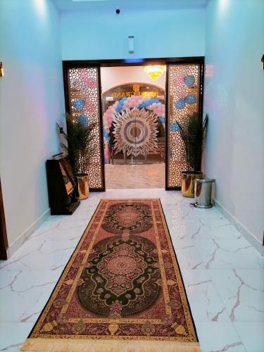 a room with a rug on a floor with a mandala rug at Hotel Grand Lahore in Lahore