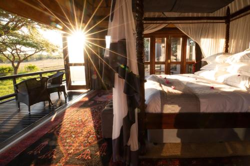 a bedroom with a bed on a balcony at Jamala Madikwe in Madikwe Game Reserve