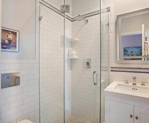 a bathroom with a glass shower and a sink at The Hermitage at Napeague in Amagansett